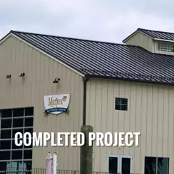 Pre-assembled clamps for metal roof snow guards safeguard walkways from snow hazards.