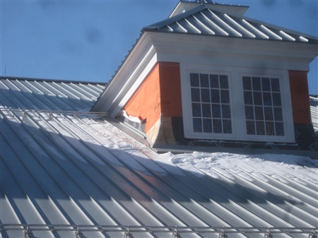 Install snow guards over structural walls.