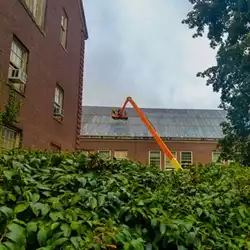 Efficient snow retention system shown as metal roof snow bars, chosen by SUNY College