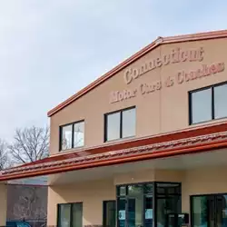 Installing AceClamp metal roof ice guards on Connecticut Motor Cars building