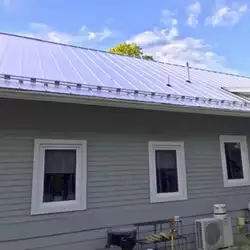 AceClamp 2-Bar Snow Bar System installed on a residential roof.