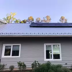 Durable metal roof featuring AceClamp snow bars for winter protection.