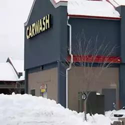 Color Snap® snow guards for metal roofing installed on car wash.